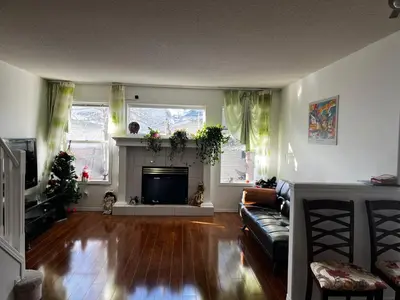 a living room with a couch and a fireplace at hidden valley new basement suite with private bathroom! in Calgary