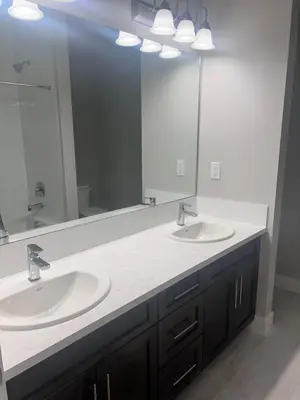a bathroom with two sinks and a large mirror at Flowealth Property Luxury Villa Near Lake Netflix TV Wifi in Calgary
