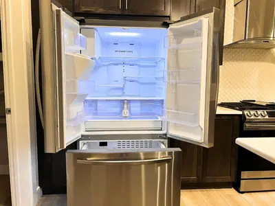 an empty refrigerator with its door open in a kitchen at Flowealth Property Luxury Villa Near Lake Netflix TV Wifi in Calgary