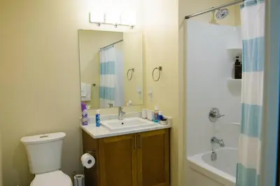 a bathroom with a toilet and a sink and a shower at Bright Modern Stylish Condo in heart of Downtown (Center) in Whitehorse