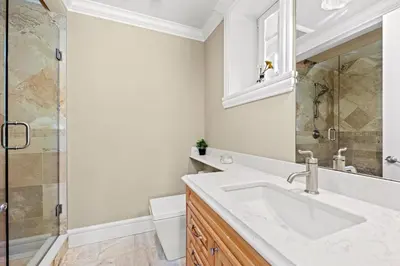 a white bathroom with a sink and a shower at Spacious Cozy House in Vancouver West in Vancouver