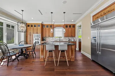 a kitchen with a table and chairs and a refrigerator at Spacious Cozy House in Vancouver West in Vancouver