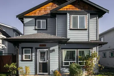 a gray house with a brown roof at Entire 3-bedroom house Near Town in Victoria