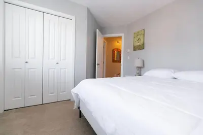 a white bedroom with a large white bed at Entire 3-bedroom house Near Town in Victoria