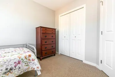 a bedroom with a bed and a wooden dresser at Entire 3-bedroom house Near Town in Victoria