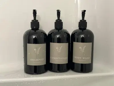 three bottles of wine sitting on a shelf at Slack tide suite in Ucluelet