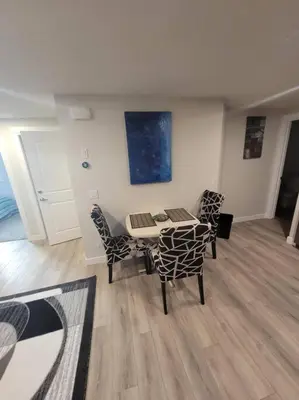 a dining room with a table and chairs in a room at Cozy brand new 2 bedroom suite in Calgary in Calgary