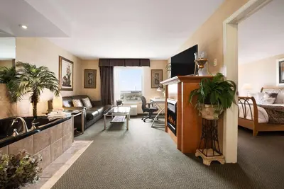 a living room with a sink and a couch at Ramada by Wyndham Clairmont/Grande Prairie in Clairmont