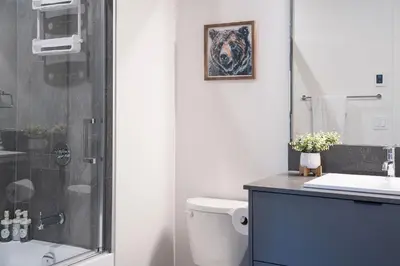 a bathroom with a shower and a toilet and a sink at Alpine Haven by Revelstoke Vacations in Revelstoke