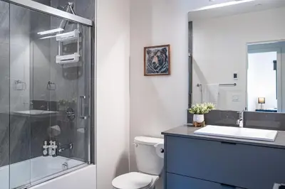 a bathroom with a shower and a toilet and a sink at Alpine Haven by Revelstoke Vacations in Revelstoke