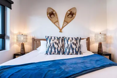 a bedroom with a bed with a heart on the wall at Alpine Haven by Revelstoke Vacations in Revelstoke