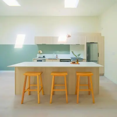 a kitchen with two orange stools and a counter at Newly Renovated 1 Bedroom Condo in Japantown! Near Gastown & Railtown! in Vancouver