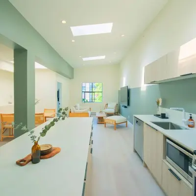 an open kitchen and living room with a couch at Newly Renovated 1 Bedroom Condo in Japantown! Near Gastown & Railtown! in Vancouver