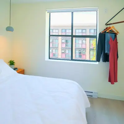a bedroom with a white bed and a window at Newly Renovated 1 Bedroom Condo in Japantown! Near Gastown & Railtown! in Vancouver