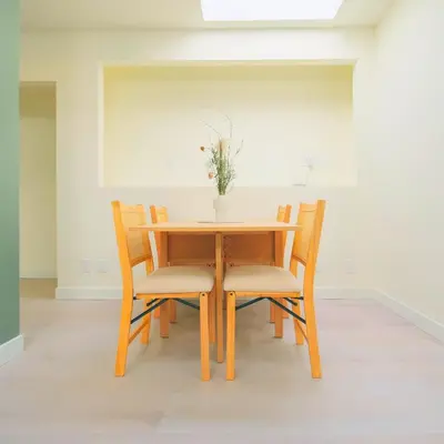 a wooden table and chairs with a vase on it at Newly Renovated 1 Bedroom Condo in Japantown! Near Gastown & Railtown! in Vancouver