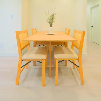 a wooden table with chairs and a vase with flowers on it at Newly Renovated 2 Bedroom Condo in Japantown! Near Railtown & Gastown! in Vancouver