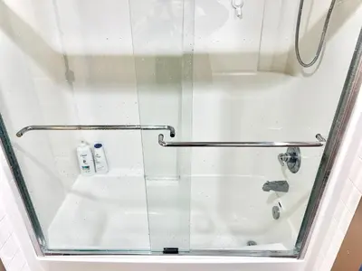 a shower with a glass door and a sink at Scorpio House Langley -ROOM 2 in Langley