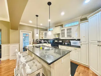 a kitchen with white cabinets and a large island at Scorpio House Langley -ROOM 2 in Langley