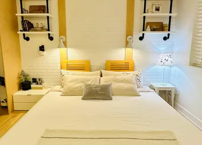 a bedroom with a large white bed with two chairs at Private Guest Suite 10mins to Downtown - King Bed - Bathtub - Free Parking in Vancouver