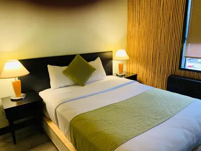 a bedroom with a large bed with two lamps at Hotel at the Waldorf in Vancouver