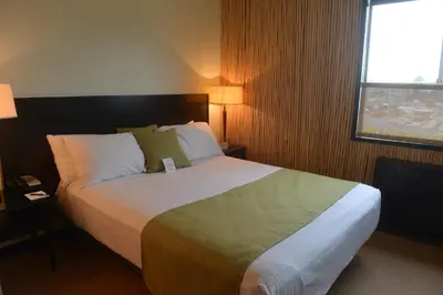 a hotel room with a bed and a window at Hotel at the Waldorf in Vancouver
