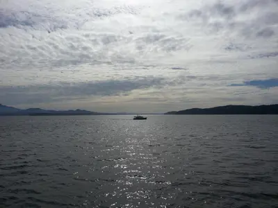 a boat in the middle of a large body of water at Orca Lodge in Sointula