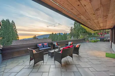 a patio with chairs and a couch and a table at Private Bedroom, Bathroom, Shared Outdoor Pool, Hot Tub in North Vancouver