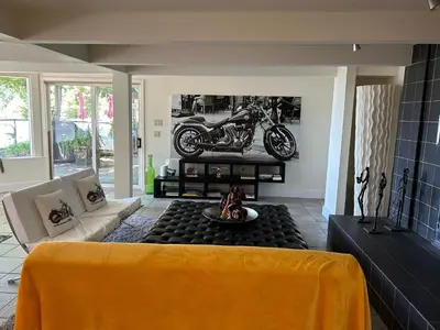 a living room with a motorcycle on the wall at Private Bedroom, Bathroom, Shared Outdoor Pool, Hot Tub in North Vancouver