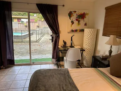 a bedroom with a bed and a desk and a window at Private Bedroom, Bathroom, Shared Outdoor Pool, Hot Tub in North Vancouver
