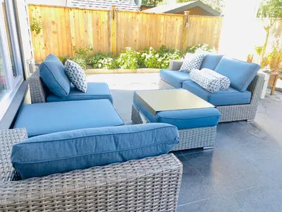 three wicker chairs and a table on a patio at Richmond Sweet home in Richmond