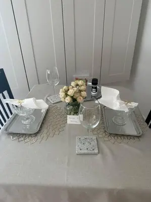 a table with three wine glasses and a vase of flowers at Carrington Chateau in Vancouver