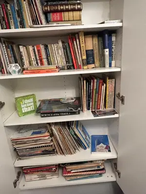 a book shelf filled with lots of books at Carrington Chateau in Vancouver