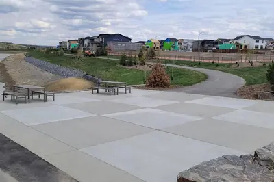 a park with benches and a road with houses at Brand New Executive Suite in Calgary