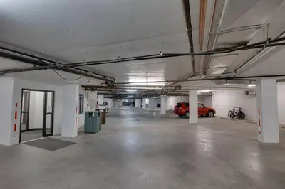 an empty parking garage with a car parked in it at Snow Creek Lodge by StayIn in Fernie