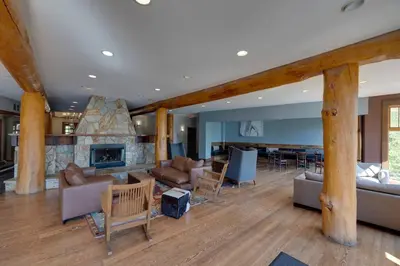 a living room with a couch and a fireplace at Snow Creek Lodge by StayIn in Fernie