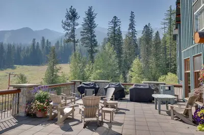a patio with chairs and tables on a balcony at Snow Creek Lodge by StayIn in Fernie