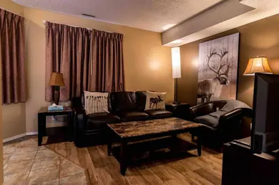 a living room with a couch and a table at Mountain view walk to all in Canmore Canada in Canmore