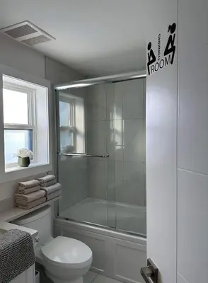 a bathroom with a shower with a toilet and a shower at 2BR 1.5BA Full Kitchen Private Guest House - Free Parking - Central Location in Vancouver