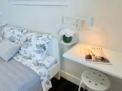 a bedroom with a bed and a desk with a book at 2BR 1.5BA Full Kitchen Private Guest House - Free Parking - Central Location in Vancouver