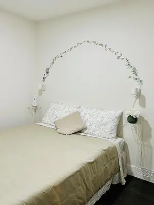 a bedroom with a bed with a white headboard at 2BR 1.5BA Full Kitchen Private Guest House - Free Parking - Central Location in Vancouver