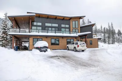 a house with a car parked in the snow at 22 Sunniva by StayIn in Fernie