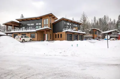 a house with a lot of snow in front of it at 22 Sunniva by StayIn in Fernie