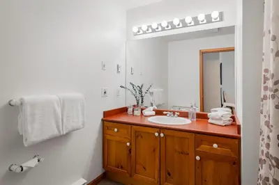 a bathroom with a sink and a mirror at Desirable Blueberry Hill in Whistler