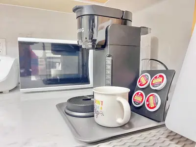 a coffee maker and a coffee cup on a counter at Si & Daniel Home Near YVR Airport & Skytrain Separate Entry Free Parking in Richmond
