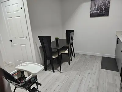 a dining room with a table and chairs at New built house, Stay in Style Guest Suite, 2bedroom, 2bed, 2bath in Edmonton