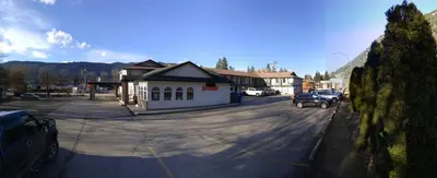 a parking lot with a car parked next to a building at Chase Country Inn in Chase