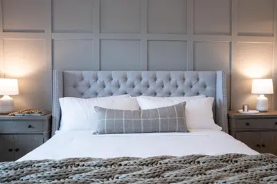 a bedroom with a large white bed with two lamps at Stoked 4Ever - Revelstoke Condo (+Hot Tub) in Revelstoke