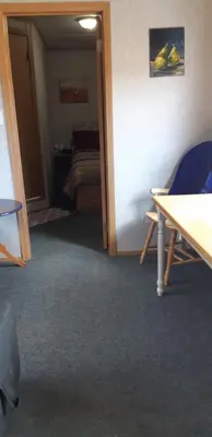 a room with a room with a table and a bed at Peace and Quiet in Lac La Biche