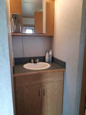 a bathroom with a sink and a mirror at Peace and Quiet in Lac La Biche