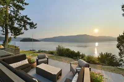 a patio with a view of a body of water at Island Luxury Oceanside Estate by EMR Vacation Rentals in Saanichton